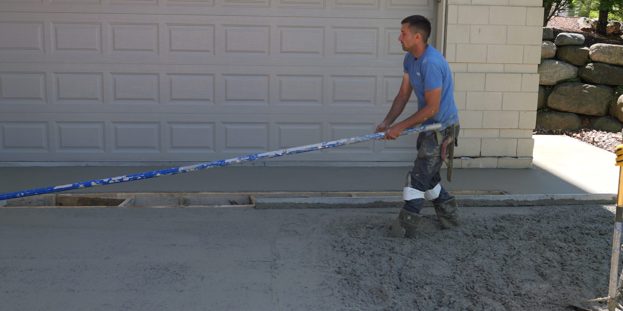 Madison concrete professionals performing a concrete driveway installation for a residential house.