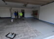 Madison, WI. professions applying an epoxy coating to a concrete garage floor.