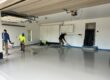 Epoxy flooring contractor applying a polyaspartic coating to concrete floors in Madison, WI.