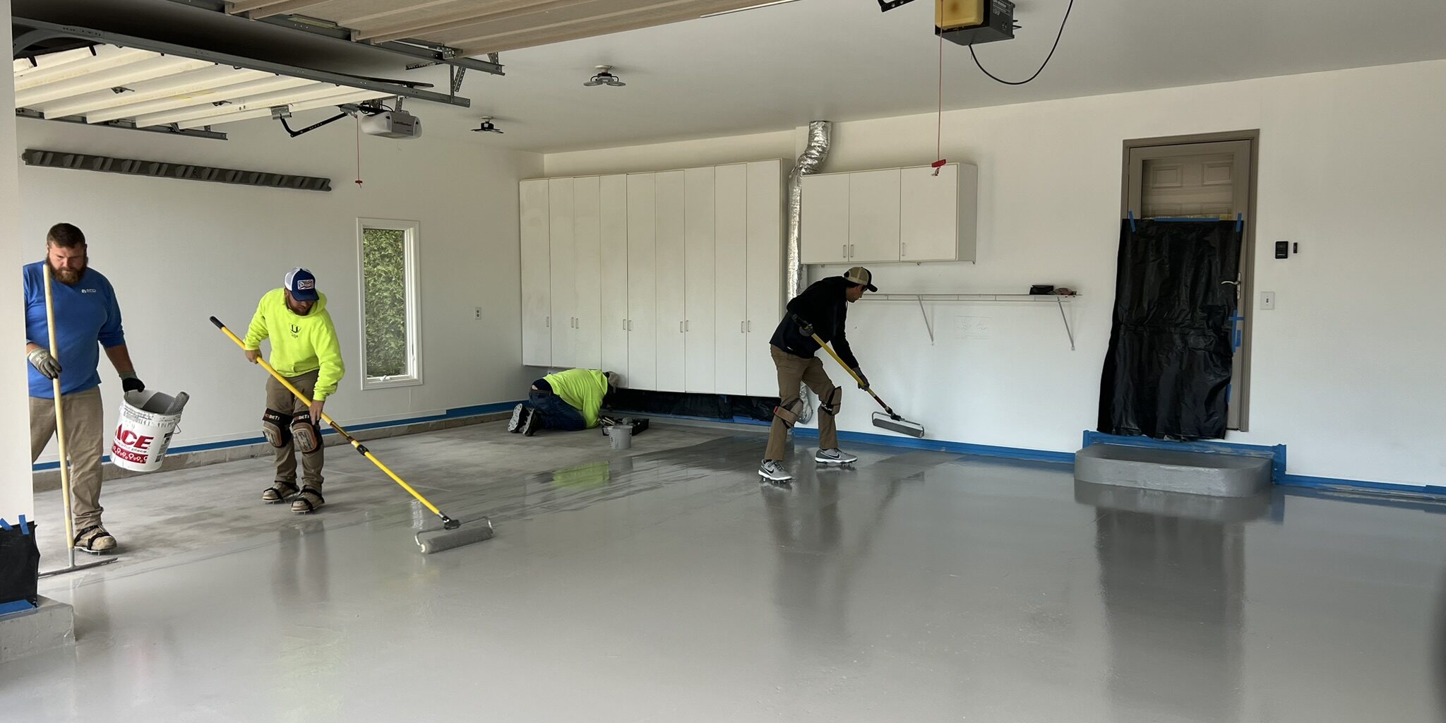 IMG_9690 Epoxy flooring contractor applying a polyaspartic coating to concrete floors in Madison, WI.