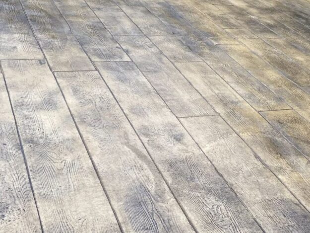 Close-up image of stamped concrete by Eco Concrete Company in Dane County, Wisconsin. The decorative concrete is designed to look like wood.